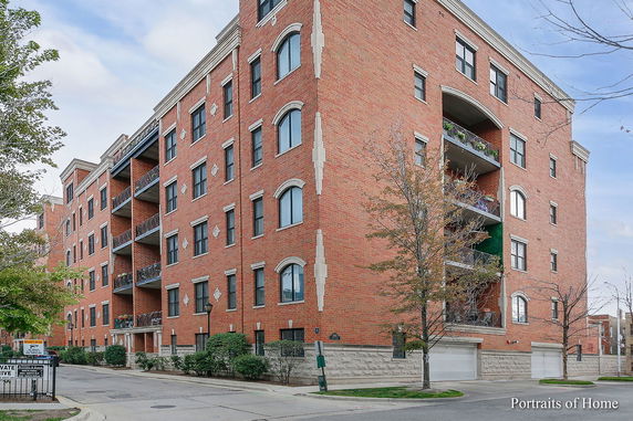 Front view of a multi-story brick building with balconies.