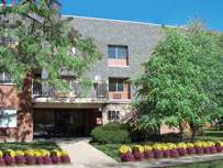 Front view of a multi-story building with a brick facade.