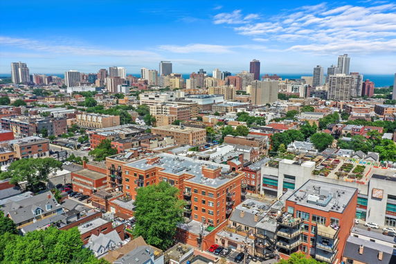 Panoramic view of a city with various high-rise and low-rise buildings.