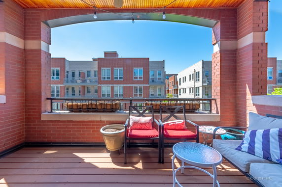 View from a balcony with red brick buildings in the background.