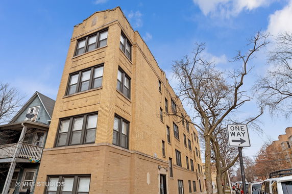 Front view of a multi-story brick apartment building