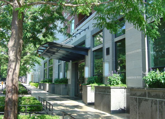 Front view of a building with large windows and an entrance canopy.