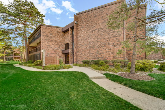 Front view of a multi-story brick building with balconies.