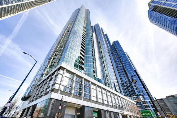 Front view of a modern high-rise building with glass facade.