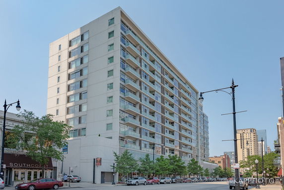 Front view of a multi-story residential building with balconies.