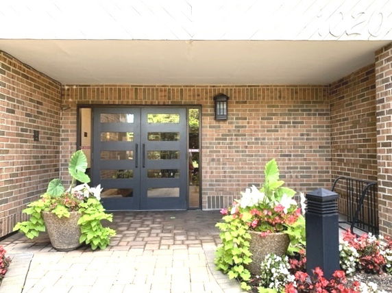 Entrance of a brick building with double doors.