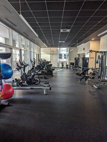 Indoor gym area with various fitness equipment.