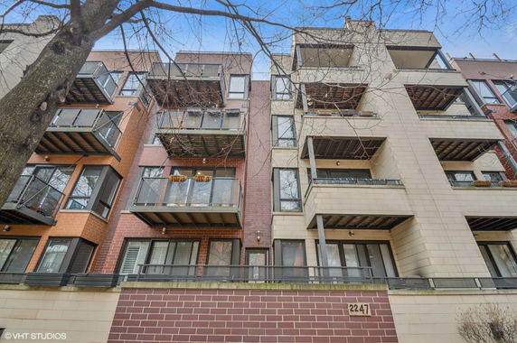 Front view of a multi-story residential building with balconies.