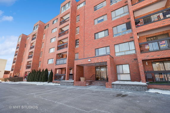 Front view of a multi-story brick apartment building.