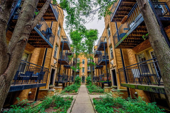 Front view of a multi-story apartment building with balconies.