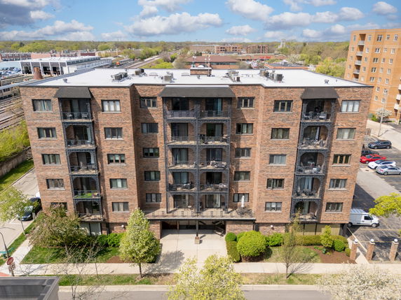 Front view of a mid-rise apartment building with balconies.