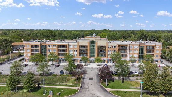 Front view of a multi-story commercial building with parking area.