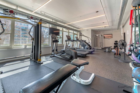 Interior view of a gym area with exercise equipment.