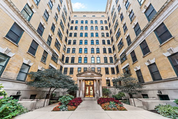 Front view of a multi-story building with numerous windows and entrance named Green Brier.
