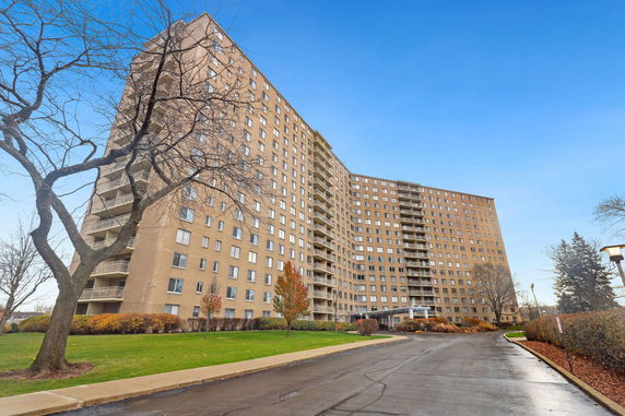 Front view of a large residential apartment building with multiple stories.