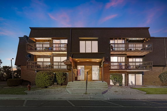 Front view of a three-story residential building with balconies.