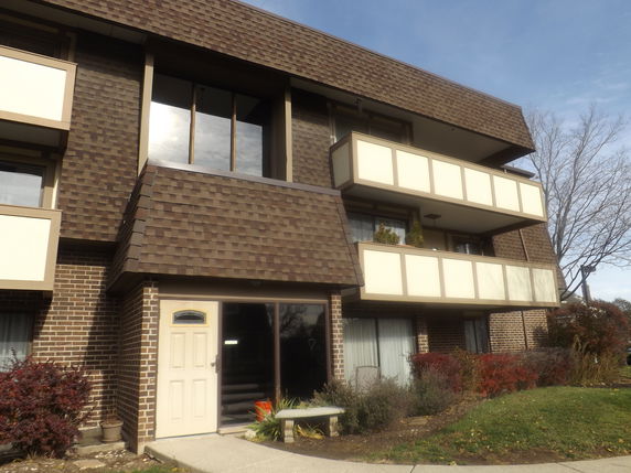 Front view of a multi-story building with balconies.