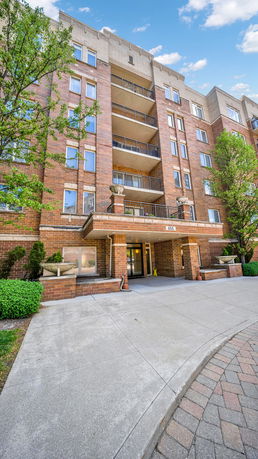 Front view of a multi-story brick residential building.