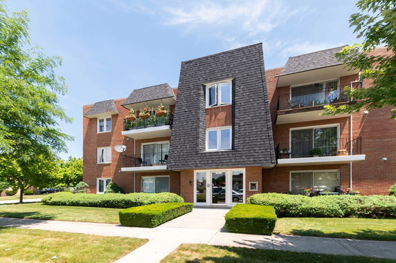 Front view of a multi-story building with balconies.
