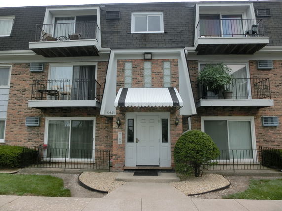 Front view of a multi-story building with balconies.