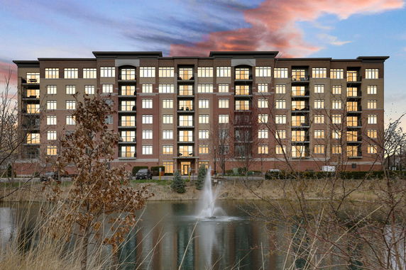 Front view of a multi-story apartment building with balconies.