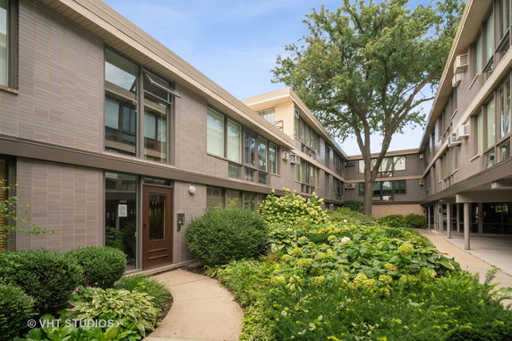 Front view of a multi-story building with a courtyard.