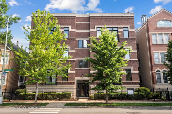 Front view of a brick multi-story residential building.