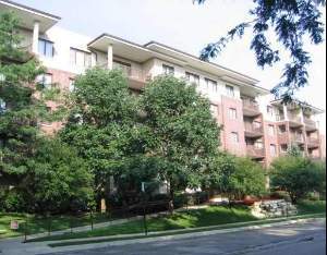 Front view of a multi-story residential building with balconies.