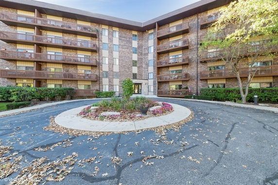 Front view of a multi-story residential building with balconies.