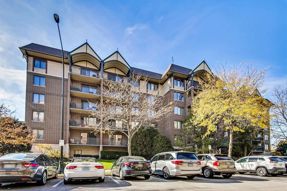 Front view of a multi-story residential building with balconies.