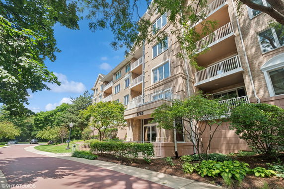Front view of a multi-story apartment building with balconies.