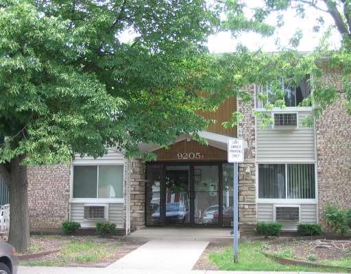 Front view of a building with brick and siding exterior.