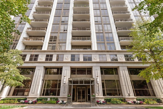 Front view of a multi-story residential building with balconies.