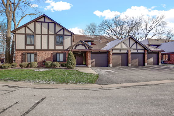 Front view of a two-story house with a triple garage.