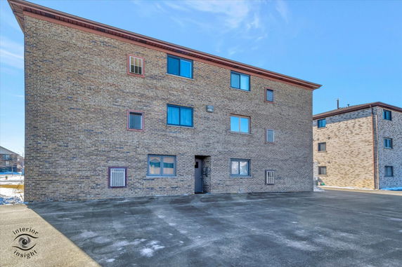 Front view of a multi-story brick building.