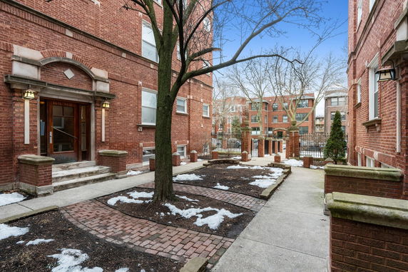 Front view of a brick apartment building entrance.