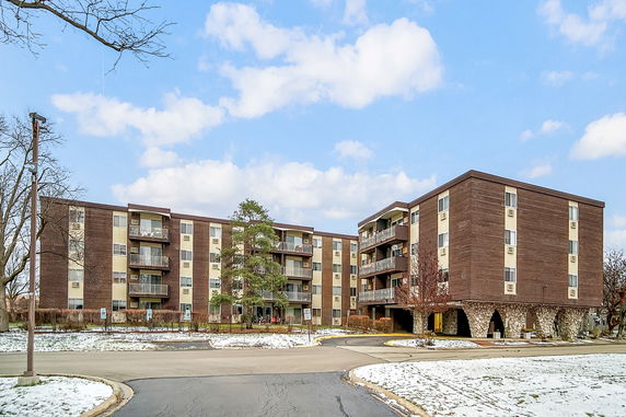 Front view of a mid-rise apartment building with balconies.