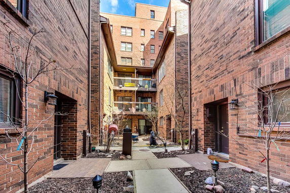 Front view of a multi-story brick building with balconies.