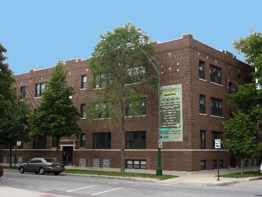 Front view of a multi-story brick apartment building.
