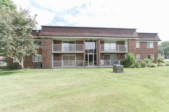 Front view of a two-story apartment building with balconies.