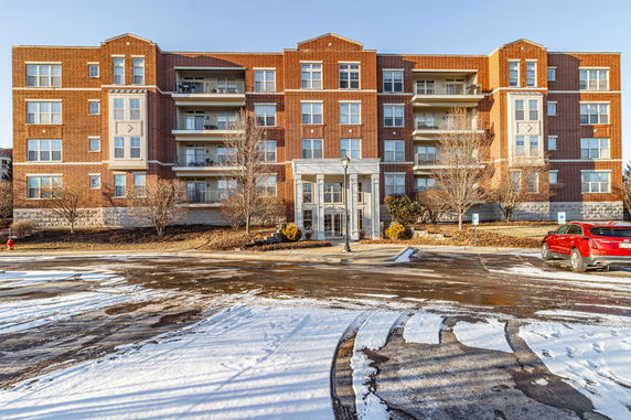 Front view of a multi-story brick apartment building.
