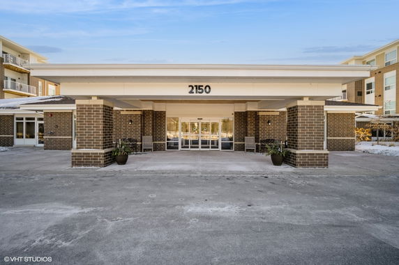 Front view of a building with a covered entrance and number 2150 displayed.