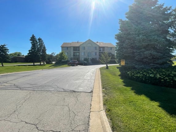 Front view of a multi-story building with a driveway.