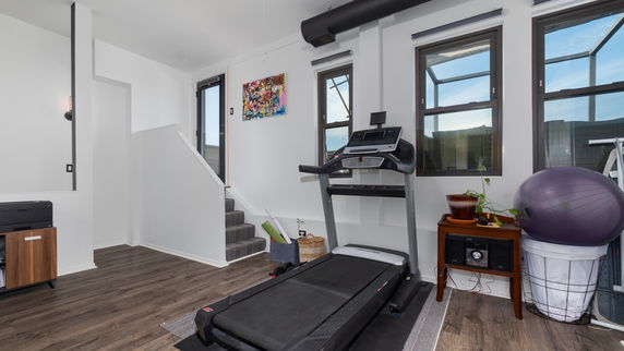 Indoor area with a treadmill and exercise equipment