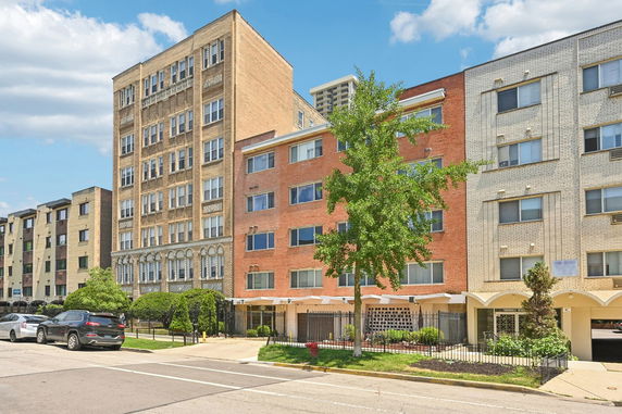 Front view of multi-story residential buildings with varied architectural styles.