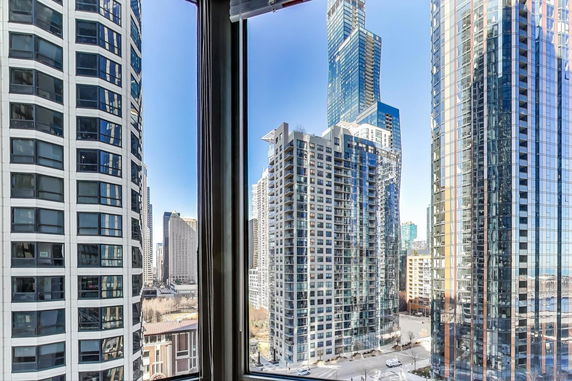 View of multiple high-rise buildings seen from a window.