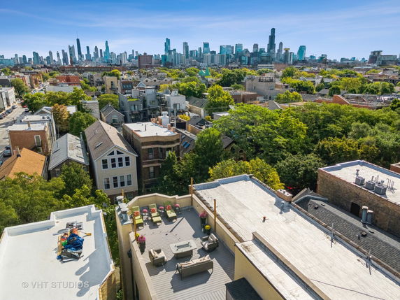 Panoramic view of a city skyline from a rooftop.