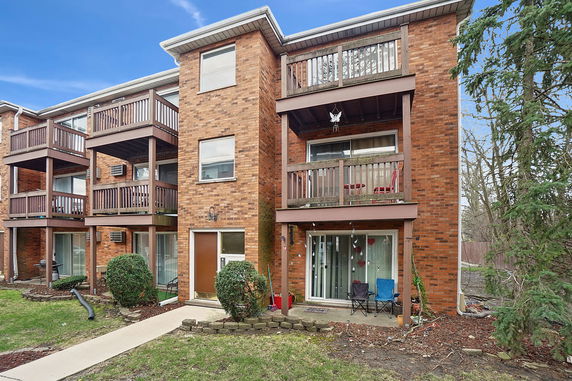 Front view of a three-story apartment building with balconies.