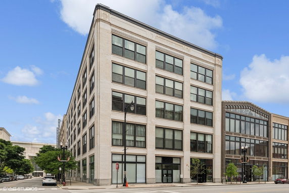 Front view of a multi-story commercial building with large windows.