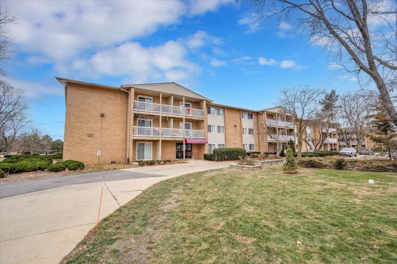 Front view of a multi-story residential building with balconies.